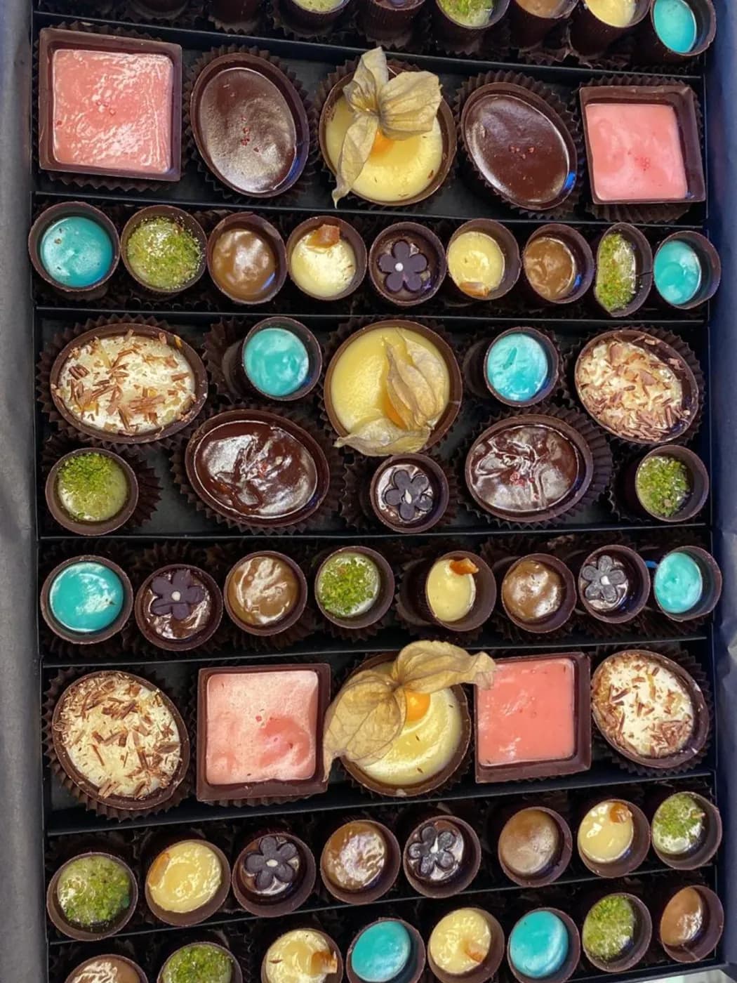 Renkli dolgulu Cup çikolatalar ve truffle'larla dolu kutunun üstten görünümü